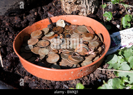 Ein Topf schmutzig und rostigen englische Münzen, meist zwei und einem Pence-Stücke Stockfoto