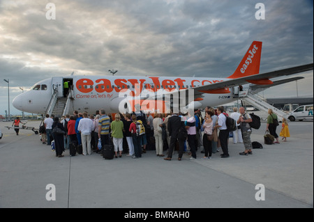 Airline Passagiere ein Flugzeug besteigen der Diskont Fluggesellschaft easyjet am Flughafen München Deutschland Stockfoto