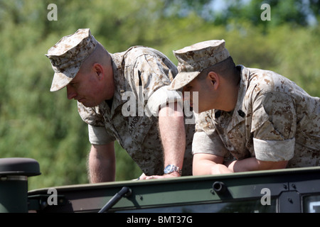 Zwei männliche US-Marines-Soldaten in einem Jeep stehen und Lächeln Stockfoto