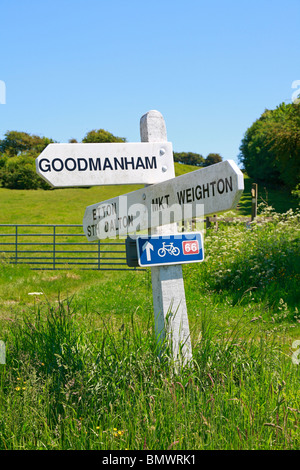 Traditionelle weiße Wegweiser in die Yorkshire Wolds mit blauen Zyklus Route 66 Schild nahe Market Weighton, East Riding of Yorkshire, England, UK. Stockfoto