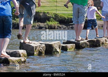 Füße über die Trittsteine auf Ogmore über den Fluss Ewenny in der Nähe von Bridgend Wales UK horizontale 104882 Stockfoto