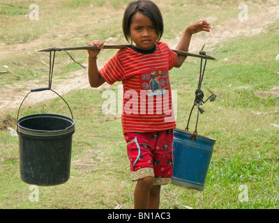 Mädchen tragen von Wasser in Kompong Phluk Village, Tonle Sap See, Kambodscha Stockfoto