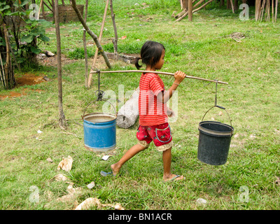 Mädchen tragen von Wasser in Kompong Phluk Village, Tonle Sap See, Kambodscha Stockfoto