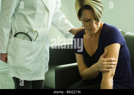 Arzt beruhigend Frau im Wartezimmer Stockfoto