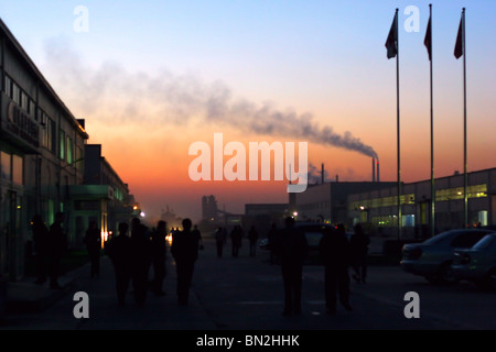 China, Beijing, Fahrrad Arbeiter verlassen die Fabrik bei Sonnenuntergang Stockfoto