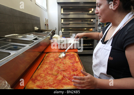 Stadien der Vorbereitung der Pizza Tomatensauce auf dem Pizzateig verteilen Stockfoto