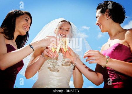 Braut mit zwei Brautjungfern gibt ein Prost mit gefüllten Sektgläsern auf Hochzeit Tag morgens immer bereit für Hochzeit Stockfoto