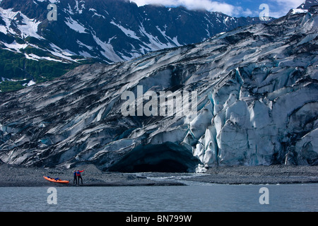 Kajak-paar zu Fuß die Küste in der Nähe von einer Eishöhle Shoup Gletscher, Shoup Bay State Marine Park, Prince WIlliam Sound, Alaska Stockfoto