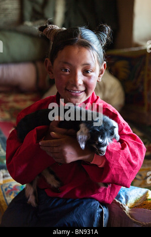 Junges Mädchen hält ein Baby Lamm in ländlichen Tibet Stockfoto