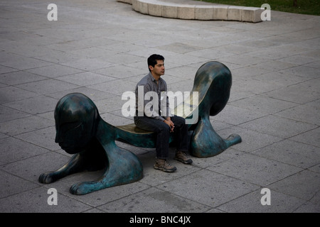 Ein Mann sitzt auf einer Bank in der Allee Paseo De La Reforma in Mexiko-Stadt, 27. November 2009. Stockfoto