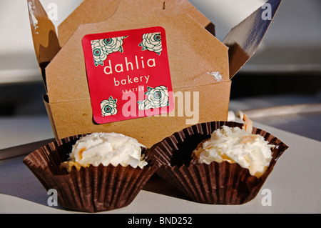 Zwei Bissen der Kokos-Sahne erscheinen vor Bäckerei Box von Dahlia Bakery in Seattle, Washington. Stockfoto