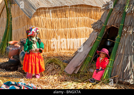 Dorfbewohner in traditioneller Tracht auf Uros schwimmende Insel im Titicacasee, Peru, Südamerika. Stockfoto