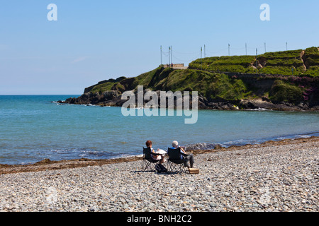 paar lesen Zeitungen am einsamen Strand im Sommer in Bray, in der Nähe von Dublin, Irland Stockfoto