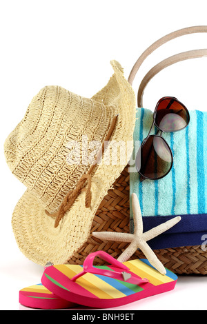 Strandtasche mit Handtuch, Stroh-Hut, Sonnenbrille und Flip Flops Stockfoto