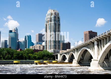 Ein Blick auf die Skyline der Minneapolis vom Westufer des Mississippi River. Im Vordergrund sieht man den Mississippi River. Stockfoto