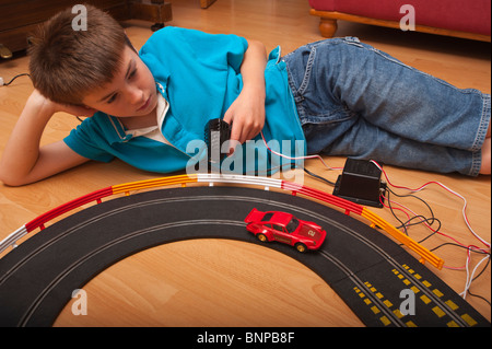 Ein Modell veröffentlicht zehn Jahre alter Junge spielt mit einem Hornby Scalextric-Rennwagen set Spiel im Vereinigten Königreich Stockfoto