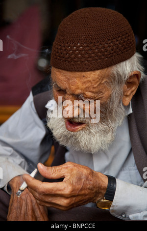 Alter Mann Rauchen in Gumrek Karawanserei in Sanliurfa, Türkei Stockfoto