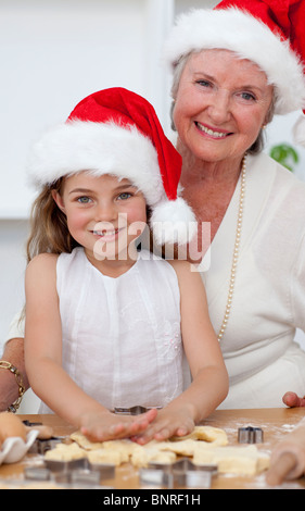 Lächelnd, Großmutter und kleines Mädchen Weihnachten Kuchen backen Stockfoto