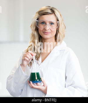 Frau in Lapcoat Blick auf Chemikalien Stockfoto