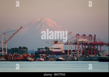 Riesige Kräne be- und Entladen der Fracht in den Hafen von Seattle, Washington, USA Schiffe ziehen im Trockendock für Reparaturen und Wartung. Stockfoto