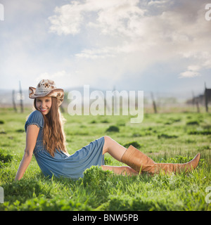 Cowgirl entspannend im Feld Stockfoto