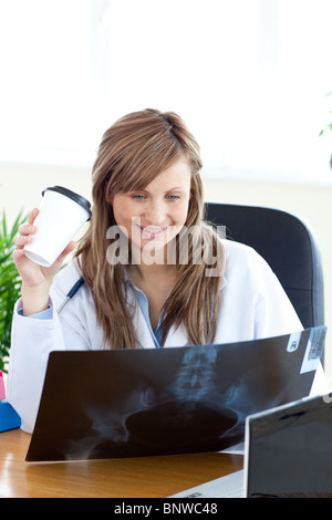 Zufrieden Ärztin Blick auf eine Radiographie Stockfoto