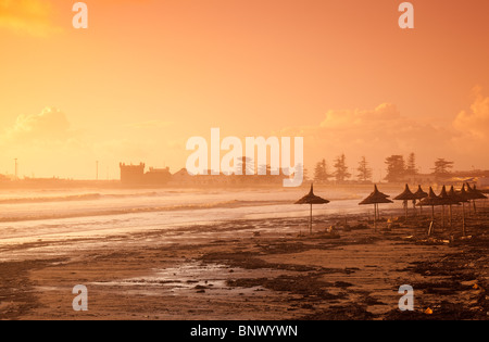 Essaouira Strand mit Sonnenschirmen und entfernt Skala du Port, Essaouira, Atlantikküste, Marokko Stockfoto