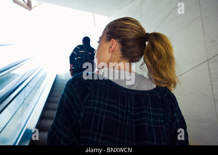 Teen Mädchen reiten Rolltreppe, Rückansicht Stockfoto