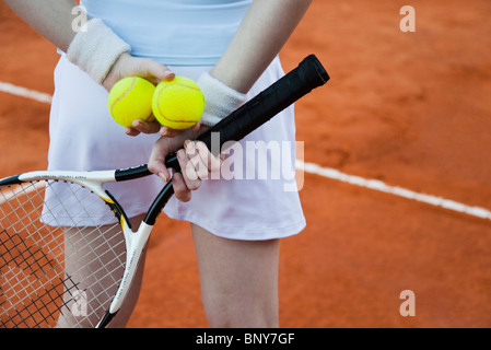 Tennisspieler mit Schlägern und Bällen hinter Rücken Stockfoto