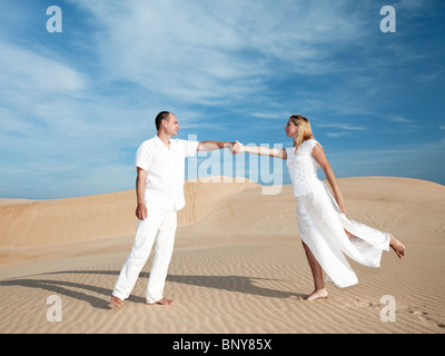 Besprechung von Mann und Frau in den Dünen der Wüste Stockfoto