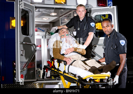Sanitäter, die Fürsorge für ältere Patienten auf Bahre in Ambulanz in der Nacht Stockfoto