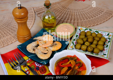 Tapas, grüne Oliven, gemischte Paprika in Olivenöl Öl, Riesengarnelen und Meeresfrüchte Sauce, Spanien. Stockfoto