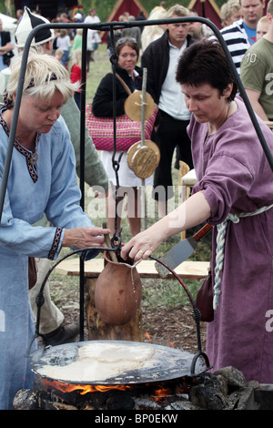 Herstellung von Pfannkuchen in Finnlands größte Wikingerfestival Markt und Reenactment Camp am Kvarnbo auf Land-Archipel Stockfoto