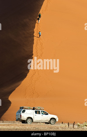 Touristen, die Düne 45 im Sossusvlei in Namibia Naukluft Park zentrale Namibwüste aufsteigend Stockfoto