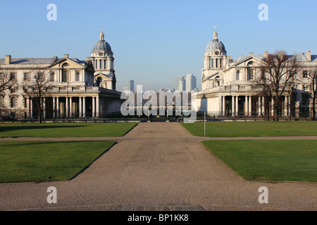 Symmetrische Ansicht des Royal Naval College aus Queens House, Greenwich, London, England, Großbritannien, mit Canary Wharf im Hintergrund Stockfoto