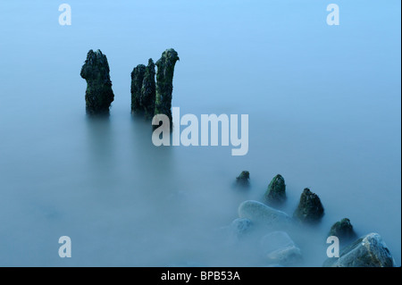 Ein Auszug aus Steinen und Holz Buhnen am Lilstock Strand, Somerset. Eine lange Verschlusszeit verursacht das Wasser zu stark verschwimmen. Stockfoto