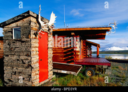 Nebengebäude, außerhalb der Toilette, im freien Loo, Geweih über rote Tür, Blockhaus am Summit Lake, AK, Alaska, USA Stockfoto