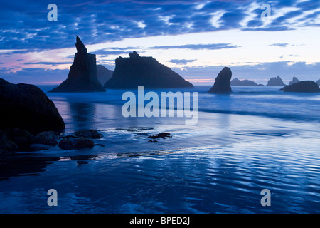 USA, Oregon, Coos County, Bandon Staatspark, Felsnadeln, Surf und Strand bei Sonnenuntergang, September Stockfoto