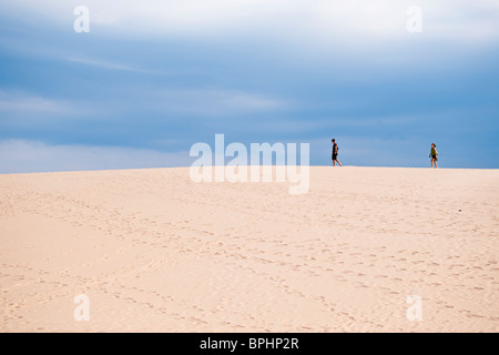 Ein Blick aus der Ferne auf ein paar Menschen, die auf der Spitze einer Sanddünen laufen Silver Lake im State Park Michigan MI Low Angle in den USA horizontale Hi-res Stockfoto