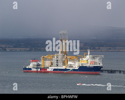 Die Stena Carron Öl bohren Schiff am Nigg Ölterminal im Cromarty Firth Schottlands. Ein Lotsenboot steht im Vordergrund. Stockfoto