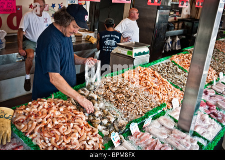 WASHINGTON DC, USA – Fischhändler, der Garnelen und Tintenfische auf dem Maine Avenue Fish Market in Washington DC verkauft. Stockfoto