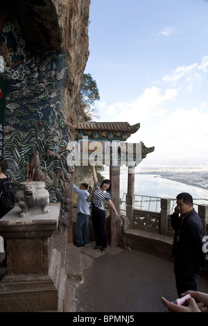 Chinesische Touristen vor Dragon Gate, Blick über Dian See, Hügel der Sleeping Buddha, Taihua Tempel, Kunming, Yunnan, Pers. Stockfoto