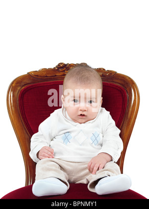 Humorvolle Foto ein vier Monate altes Baby Junge sitzt auf einem Stuhl wie ein König auf einem Thron Stockfoto