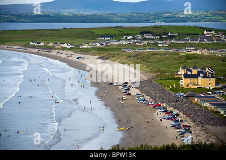 Rossnowlagh County Donegal Irland geparkten Autos am Strand wie Menschen Surfen spielen und Baden im Meer Stockfoto