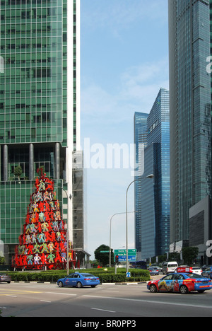 Street View in Singapur Raffles Quay mit David Gerstein der Skulptur Dynamik. Taxis, die durch Bewegung etwas verschwommen. Stockfoto