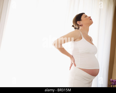 italienische 7 Monate schwangere Frau den Rücken massieren. Horizontale Form, Seitenansicht, Textfreiraum Stockfoto