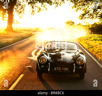 Ein Sportwagen getrieben entlang einer Landstraße an einem Sommerabend Stockfoto
