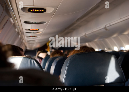 Flugzeug innen mit Reihen von sitzenden Passagieren Stockfoto