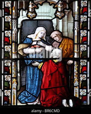 Ein Buntglasfenster von Lavern, Barraud & Westlake, das eine der Corporal Acts of Mercy darstellt; Fütterung der Hungrigen, Marhamchurch Church, Cornwall Stockfoto