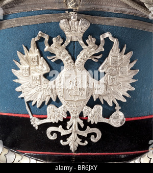 Ein Kiwer für Generalstabsoffiziere, ca. 1910. Schwarzer Lederdeckel und blaugrüne Filzabdeckung. Schwarzes Samtband mit roter Paspel. Breite und schmale silberne Schnürsenkel. Schwarz lackiertes Leder mit versilberter Messingeinkantung. Konvexe, silverierte Metall-Chinskalen mit Lederunterlage. Auf der Vorderseite ein eingeprägter, versilberter Adler. Silberfarbene Schnur an versilberten Schraubenknöpfen. Maker-Name auf der Rückseite der Tasten 'Br. Wunter SPB'. Cockade ersetzt(?). Leder-Sweatband. Futter gerissen. Unter den Spuren eines früheren Labels. Historisch, historisch, 1910er, Stockfoto